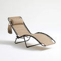 Elvatera gray folding lounge chair with sleek lines, positioned diagonally, showcasing its relaxed and versatile design.